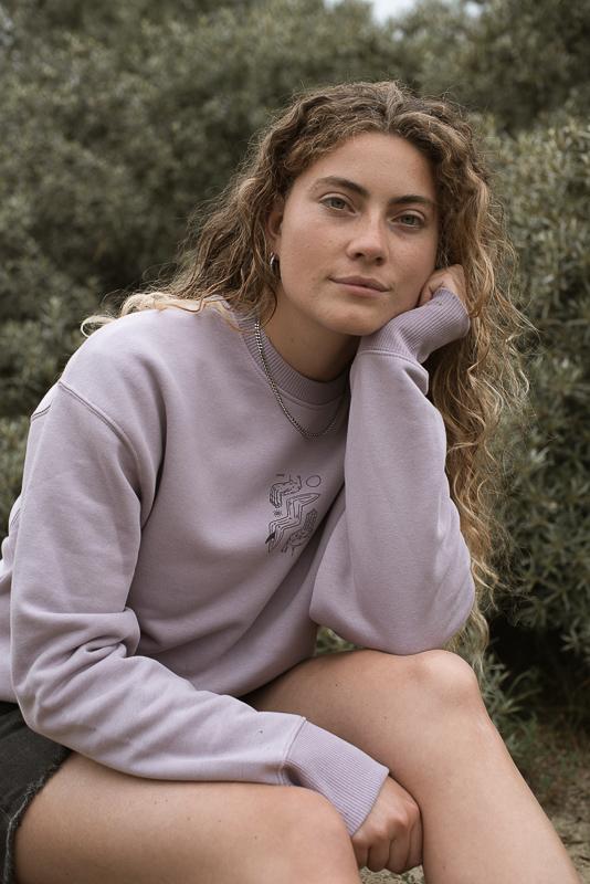 Woman Posing With Purple Crewneck Of Inmind Clothing With Hands For Feet Collab