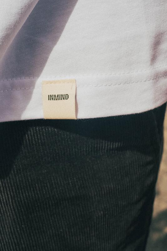 Detail Picture Of Inmind Eco Label On The Bottom Of A T-Shirt