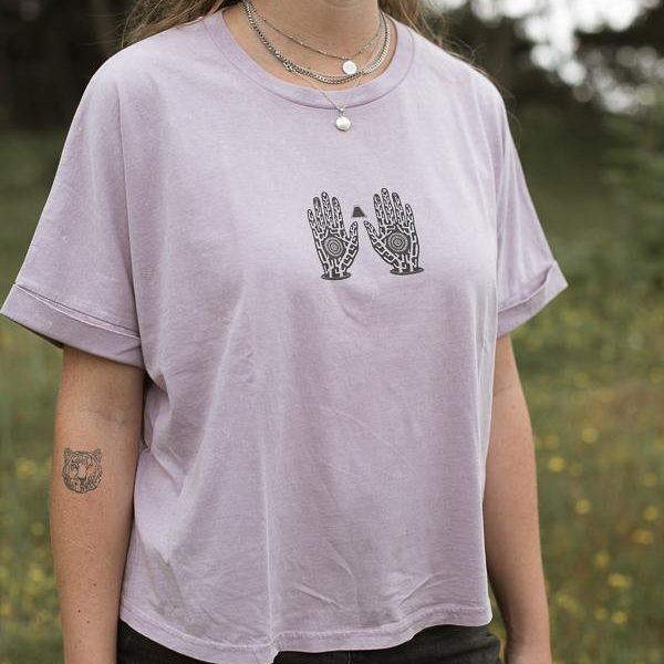 women posing with lilac women tee in front of green field