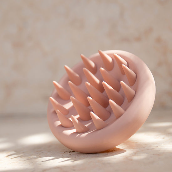 Pink Scalp Massager On Marble Surface